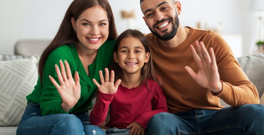 portrait-of-happy-family-waving-hands-at-camera-e1658899774792.jpg